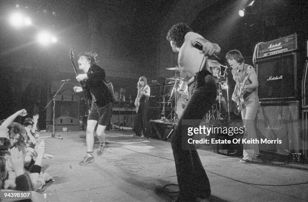 Australian rock band AC/DC perform at the Kursaal Ballroom on Canvey Island, 19th March 1977. From left to right, Angus Young, Malcolm Young, Bon...