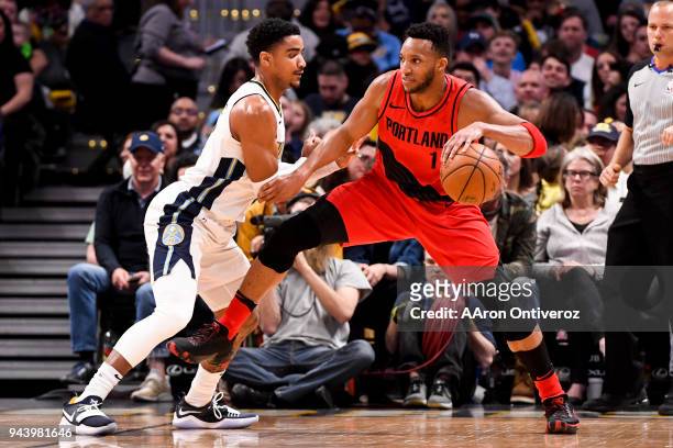 Evan Turner of the Portland Trail Blazers backs down Gary Harris of the Denver Nuggets during the first half on Monday, April 9, 2018.