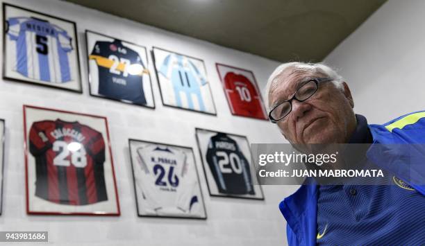 Argentinian football talent scout Ramon Maddoni poses next to jerseys given to him by football stars he scouted at Club Parque in Buenos Aires on...