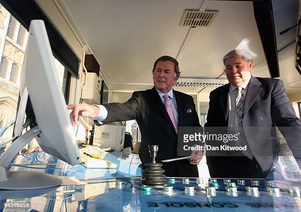 Sir Terry Wogan looks at a computer monitor inside the control tower on Tower Bridge on December 14, 2009 in London, England. Sir Terry was invited...