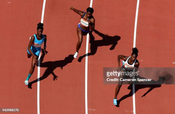 Dina Asher-Smith of England, Hafsatu Kamara of Sierra Leone and T-Kailah Richardson of Anguilla compete in the Women's 200 metres heats during the...