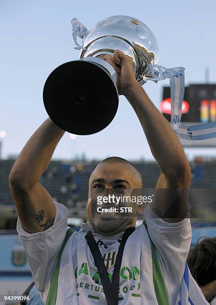 Uruguayan forward Santiago Silva of Banfield holds the trophy after winning Argentina's first division football Championship at La Bombonera Satadium...