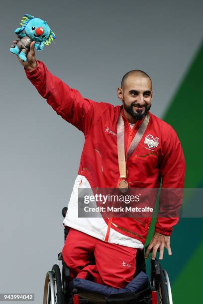 Bronze medalist Ali Jawad of England celebrates during the medal ceremony for the Para Powerlifting on day six of the Gold Coast 2018 Commonwealth...