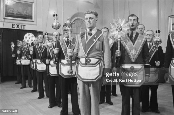 Members of the 'Pride of Clapham' lodge of the Manchester Unity of Odd Fellows, an independent friendly society, in their full regalia, August 1939....