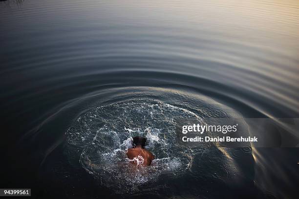 Man washes himself on the banks of the Yamuna river on December 14, 2009 in Delhi, India. In a city of approximately 16 million, over a quarter of...