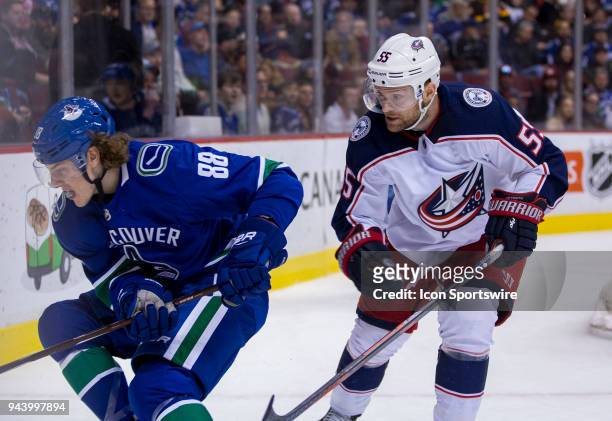 Columbus Blue Jackets Center Mark Letestu checks Vancouver Canucks Center Adam Gaudette during the third period in a NHL hockey game on March 31 at...