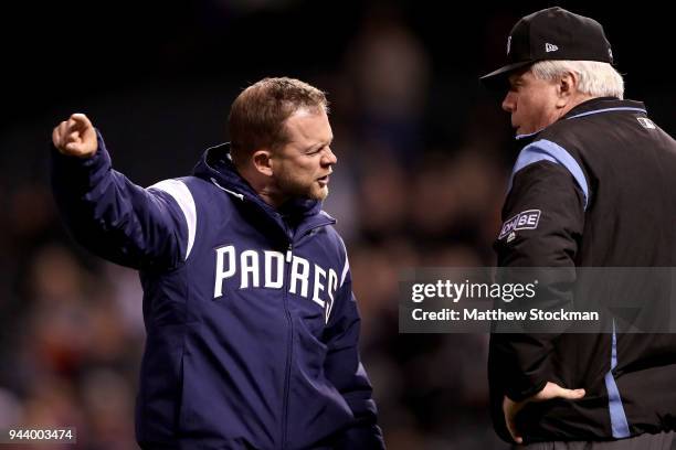 Manager Andy Green of the San Diego Padres disputes a home run call with umpire Brian Gorman in the sixth inning against the Colorado Rockies at...