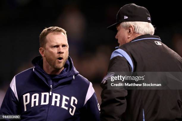 Manager Andy Green of the San Diego Padres disputes a home run call with umpire Brian Gorman in the sixth inning against the Colorado Rockies at...