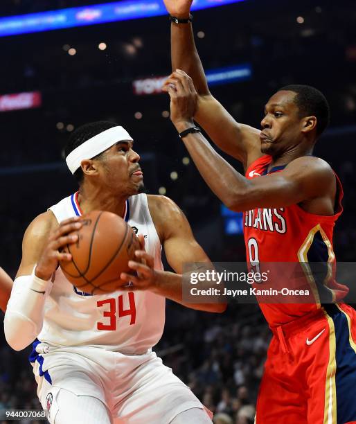 Rajon Rondo of the New Orleans Pelicans defends against Tobias Harris of the Los Angeles Clippers as he goes for a shot in the first half of the game...