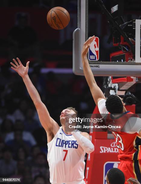 Sam Dekker of the Los Angeles Clippers defends a pass to Anthony Davis of the New Orleans Pelicans in the first half of the game at Staples Center on...