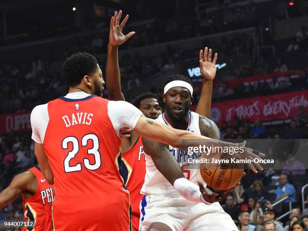 Montrezl Harrell of the Los Angeles Clippers passes against Anthony Davis of the New Orleans Pelicans in the first half of the game at Staples Center...