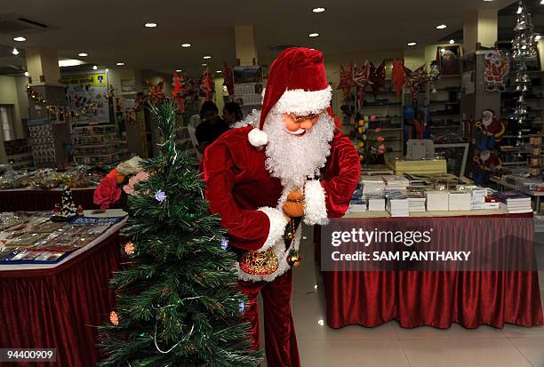 Life-size movable Santa Claus welcomes customers at the Bible Book Room in Ahmedabad on December 14, 2009. The Bible Book Room, a unit of Bible...