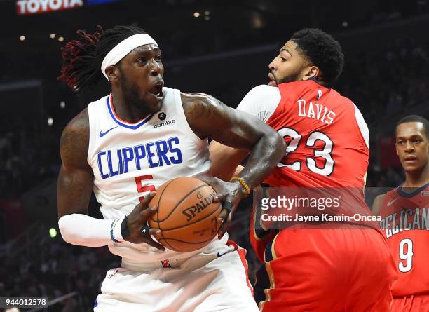 Montrezl Harrell of the Los Angeles Clippers looks to shoot against Anthony Davis of the New Orleans Pelicans in the first half of the game at...