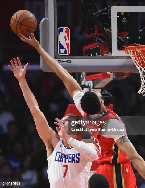 Anthony Davis of the New Orleans Pelicans receives a pass against Sam Dekker of the Los Angeles Clippers in the first half of the game at Staples...