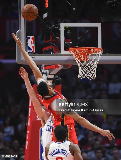 Anthony Davis of the New Orleans Pelicans reaches for a pass against Sam Dekker of the Los Angeles Clippers defends a pass to in the first half of...