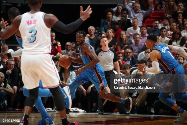 Jerami Grant of the Oklahoma City Thunder handles the ball against the Miami Heat on April 9, 2018 at American Airlines Arena in Miami, Florida. NOTE...