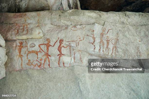 ancient paintings on the wall cave in thailand - cave man foto e immagini stock