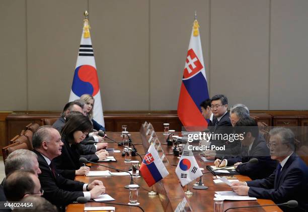 South Korean President Moon Jae-in talks with Slovakia's President Andrej Kiska during their meeting at Presidential Blue House on April 10, 2018 in...