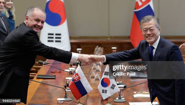 South Korean President Moon Jae-in shakes hands with Slovakia's President Andrej Kiska during their meeting at Presidential Blue House on April 10,...