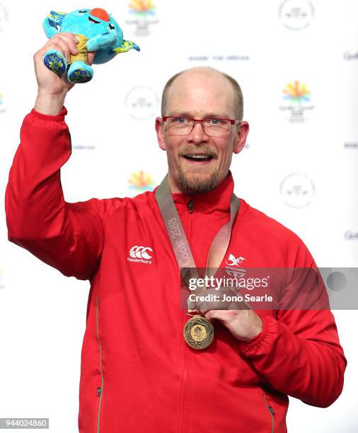 Gold Medalist David Phelps of Wales celebrates winning gold during the medal ceremony for Shooting Men's 50m Rifle Prone on day six of the Gold Coast...