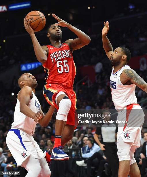 Twaun Moore of the New Orleans Pelicans drives between C.J. Williams and Sindarius Thornwell of the Los Angeles Clippers for a basket in the second...