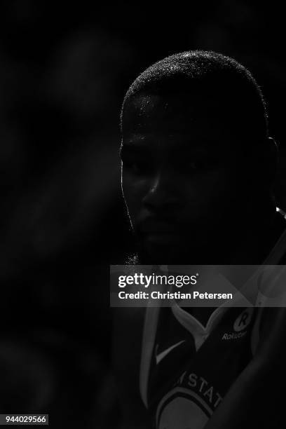 Kevin Durant of the Golden State Warriors watches from the bench during the first half of the NBA game against the Phoenix Suns at Talking Stick...
