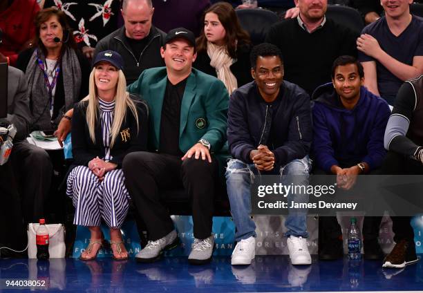 Justine Karain Reed, Patrick Reed, Chris Rock and Aziz Ansari attend New York Knicks Vs Cleveland Cavaliers at Madison Square Garden on April 9, 2018...