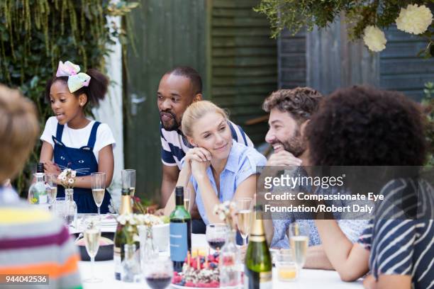 friends and family talking at lunch on patio - dark haired man gray shirt with wine stock pictures, royalty-free photos & images