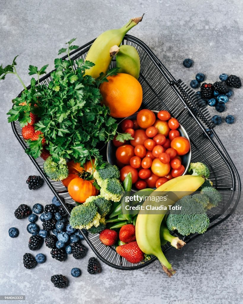 A basket of fresh vegetables, and fruits