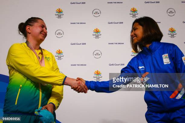 Silver medallist Australia's Elena Galiabovitch congratulates gold medallist India's Heena Sidhu at the awards ceremony following the women's 25m...
