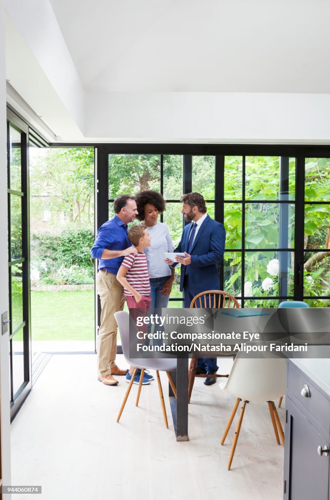 Financial advisor meeting with family in kitchen