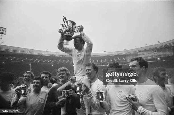 Leeds United FC captain Billy Bremner and fellow soccer players hold trophies after winning the Football League Cup Final against Arsenal FC, Webley...