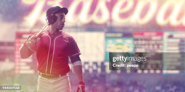 portrait of professional male baseball player in front of scoreboard - baseball scoreboard stock pictures, royalty-free photos & images