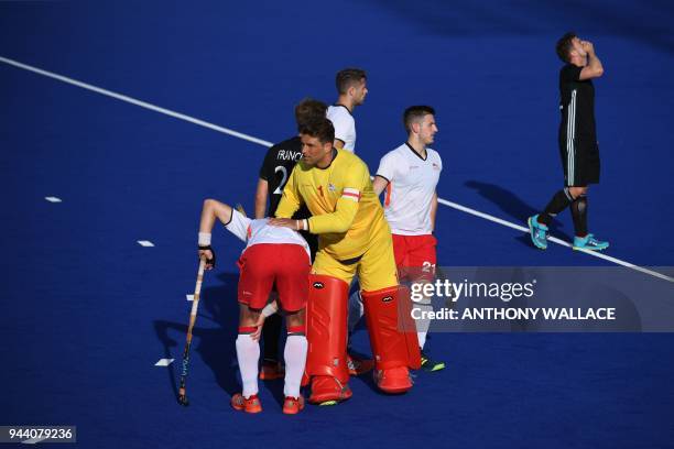 England goalkeep and captain George Pinner celebrates with his teammates after their victory over Wales after the men's field hockey match between...