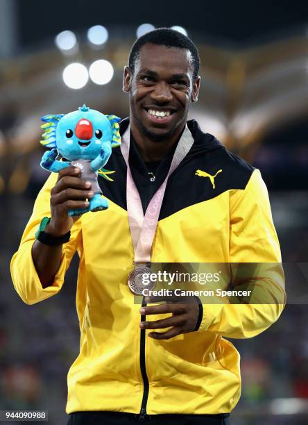 Bronze medalist Yohan Blake of Jamaica celebrates during the medal ceremony for the Mens 100 metres during the Athletics on day six of the Gold...