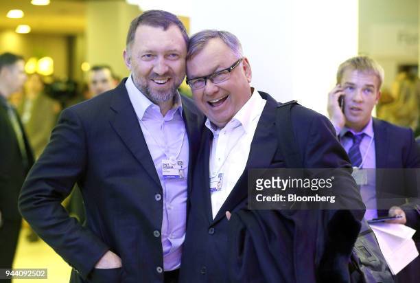 Oleg Deripaska, billionaire and chief executive officer of United Co. Rusal, left, and Andrey Kostin, chief executive officer of VTB Group, react as...