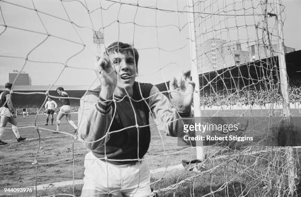 British soccer player Martin Peters of West Ham United FC in the back of the net after scoring against Liverpool, UK, 22nd April 1968.