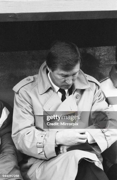 Manchester United manager Alex Ferguson checks his watch in the dugout during the League Division One match against Charlton Athletic at The Valley...