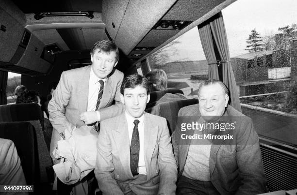 Former Liverpool manager Bob Paisley with Manchester United manager Alex Ferguson and captain Bryan Robson on the United coach, 26th December 1986.