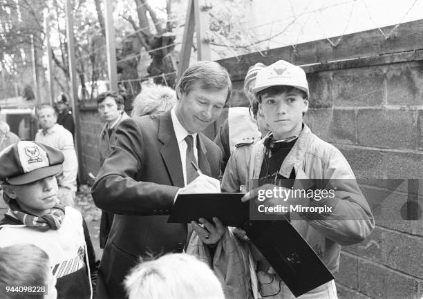 New Manchester United manager Alex Ferguson signs autographs for young Oxford United fans at the Manor Ground before his first match in charge as...