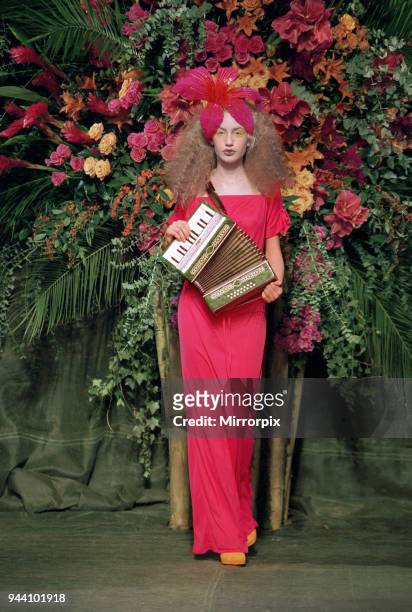 Elizabeth Jagger, daughter of Mick Jagger and Jerry Hall, wearing a hot fuchsia pink dress with an oversized orchid in her hair as she makes her...