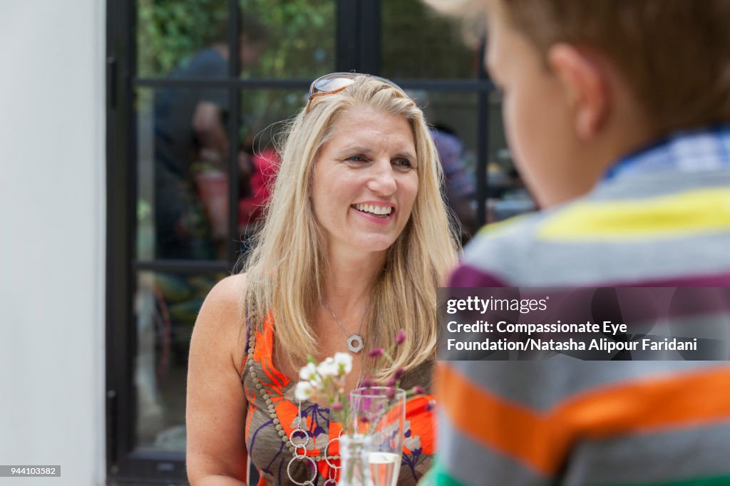 Smiling woman enjoying lunch on garden patio