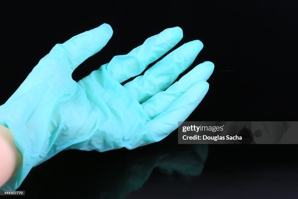 Medical exam glove on a black background