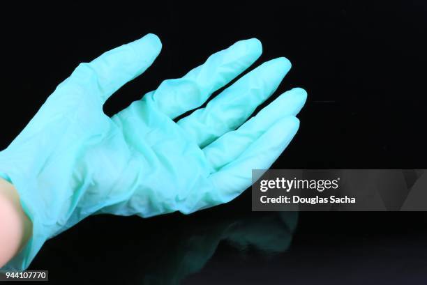 medical exam glove on a black background - hospital acquired infection stock pictures, royalty-free photos & images