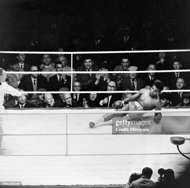 Action during the non-title heavyweight fight between American Cassius Clay and British fighter Henry Cooper at Wembley Stadium, London, Thirty five...