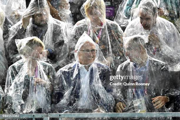 Prime Minister of Australia Malcolm Turnbull takes shelter from the rain during the swimming on day six of the Gold Coast 2018 Commonwealth Games at...