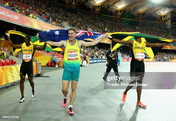 Gold medalist Ronald Levy of Jamaica, silver medalist Hansle Parchment of Jamaica and bromze medalist Nicholas Hough of Australia celebrate after the...