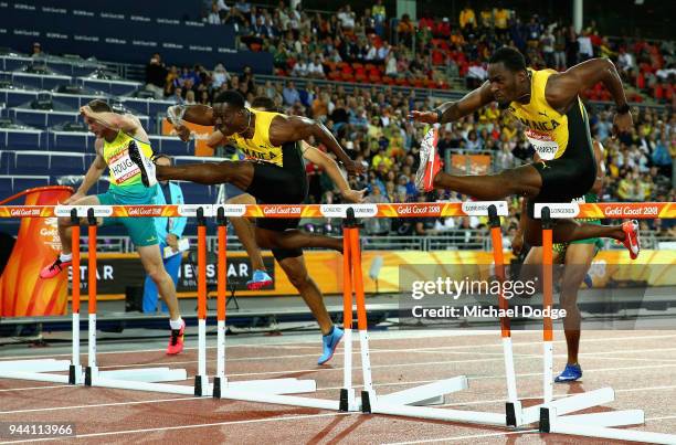 Ronald Levy of Jamaica and Hansle Parchment of Jamaica clear the final hurdle in the Men's 110 hurdles final during the Athletics on day six of the...
