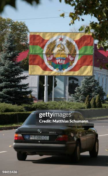 Mercedes car pass October 19, 2008 a bill showing the Transnistrian flag in Tiraspol in the Transnistria region in Moldova. Tiraspol is the second...