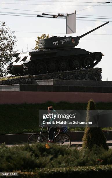 Cyclist pass October 19, 2008 a Soviet T-34 tank, commemorating the Soviet victory in World War II in Tiraspol in the Transnistria region in Moldova....